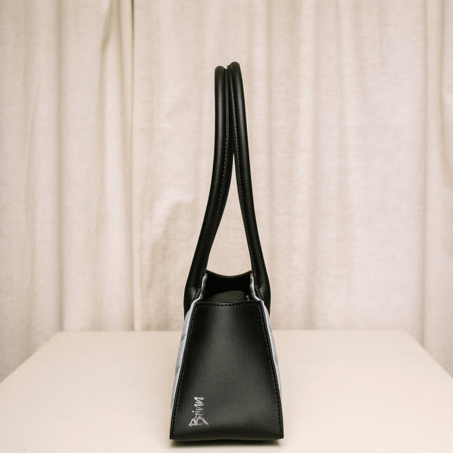 Side view of Honeypie Purse by Brinn highlighting the black cactus leather and embossed Brinn logo on the side of the bag